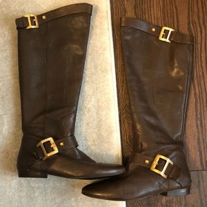 Tall brown boots with gold buckles